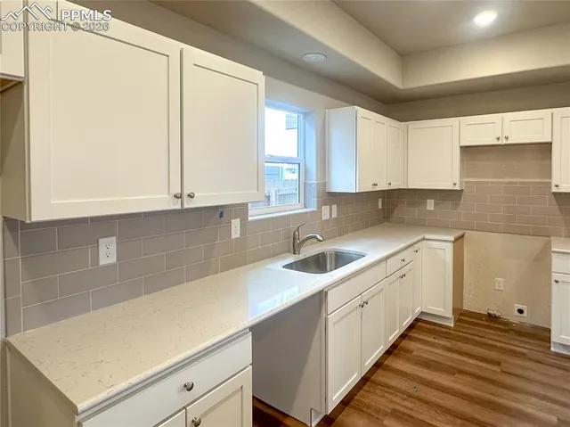 a kitchen with a sink and cabinets