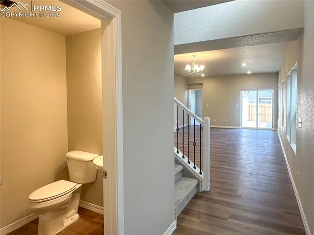a bathroom with a toilet and a mirror
