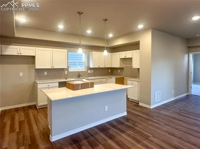 a kitchen with stainless steel appliances granite countertop a sink a stove and a refrigerator