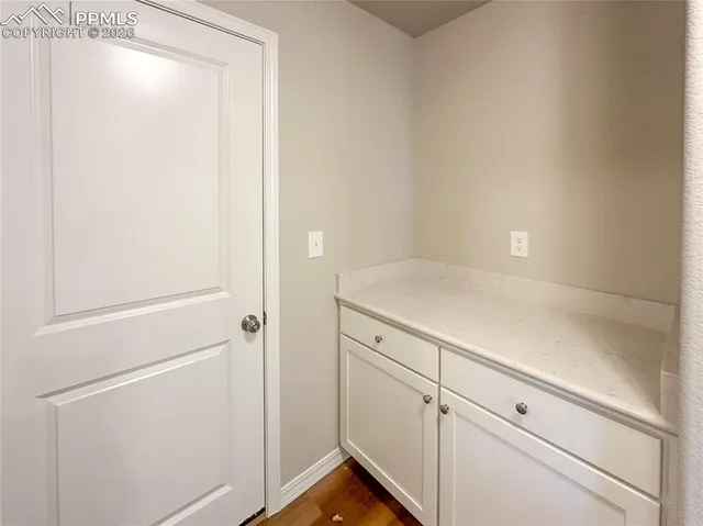 a view of a kitchen with wooden floor