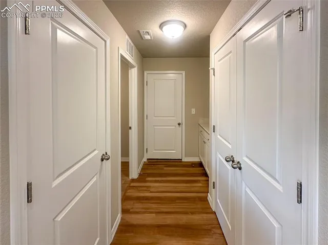 a view of a room with wooden floor and cabinet