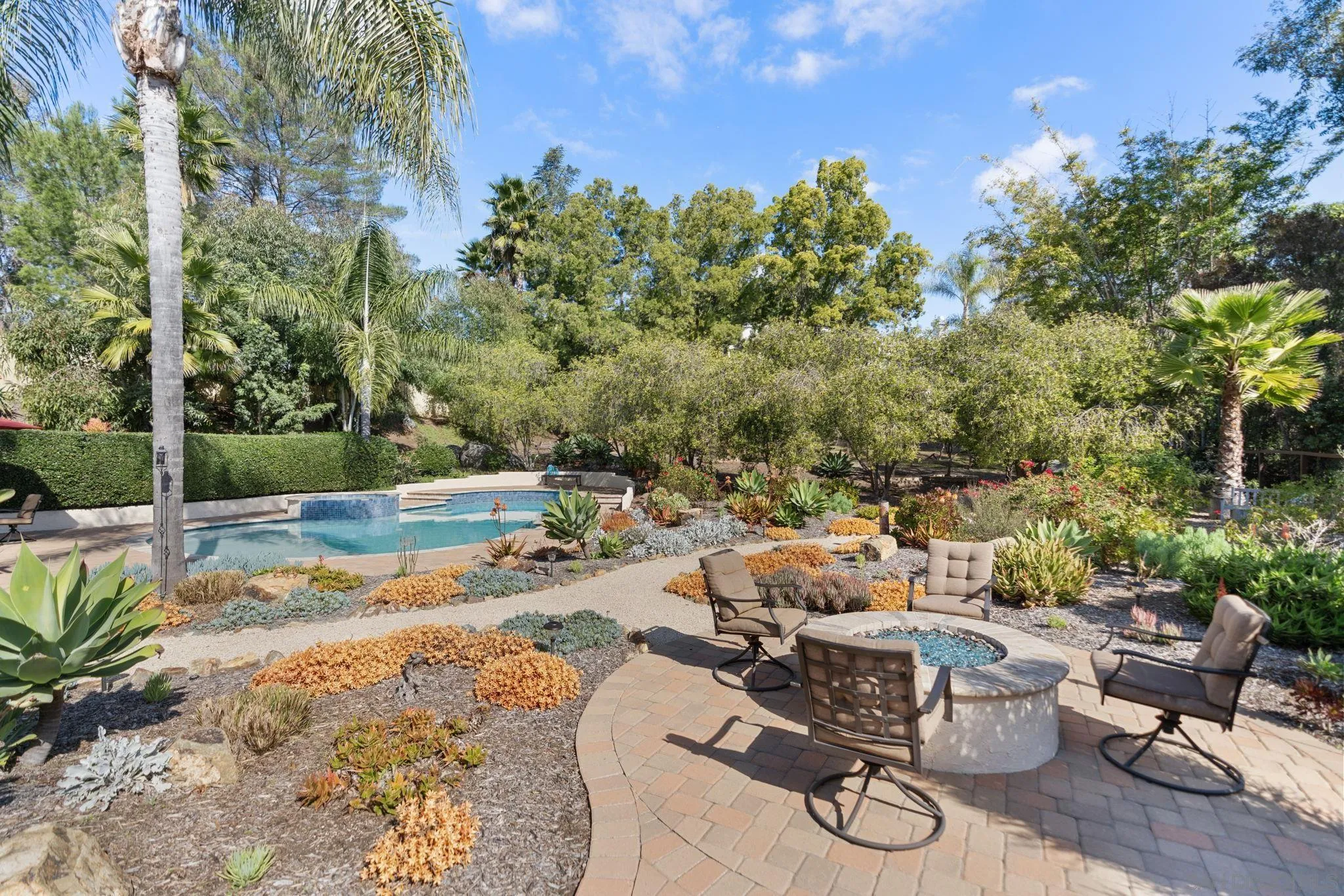 452 Avenida Adobe Escondido, CA 92029 - Photo 8 of 11 a view of a swimming pool with lawn chairs and potted plants