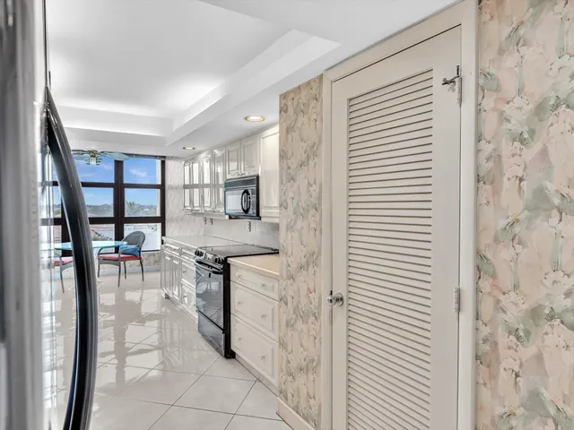 a spacious bedroom with a large bed and a large window