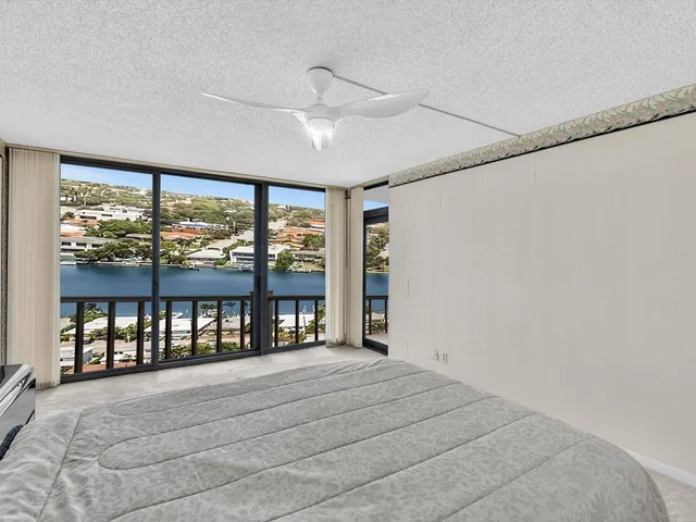 a vase of flowers sitting on a table with a chandelier