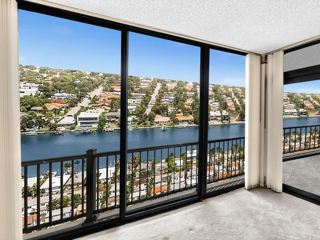 a living room with furniture ceiling fan and a large window