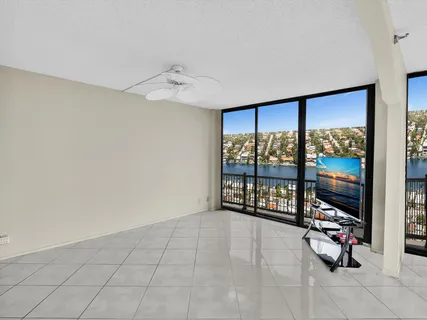 an aerial view of ocean and residential houses with outdoor space