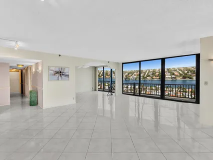 a kitchen with stainless steel appliances kitchen island granite countertop a refrigerator and a sink