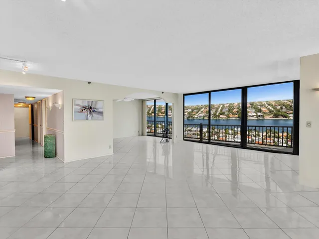 a kitchen with stainless steel appliances kitchen island granite countertop a refrigerator and a sink