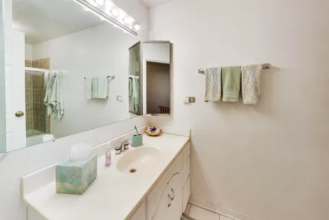 a spacious bathroom with a double vanity sink and mirror