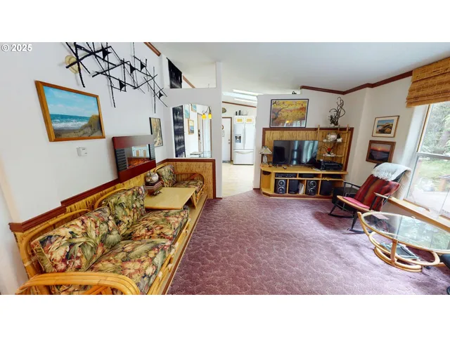 a living room with furniture a flat screen tv and a wall painting