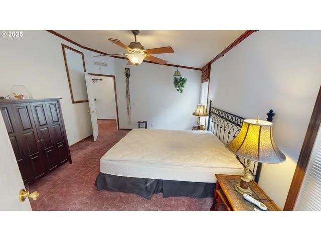 a bed room with a bed and wooden floor