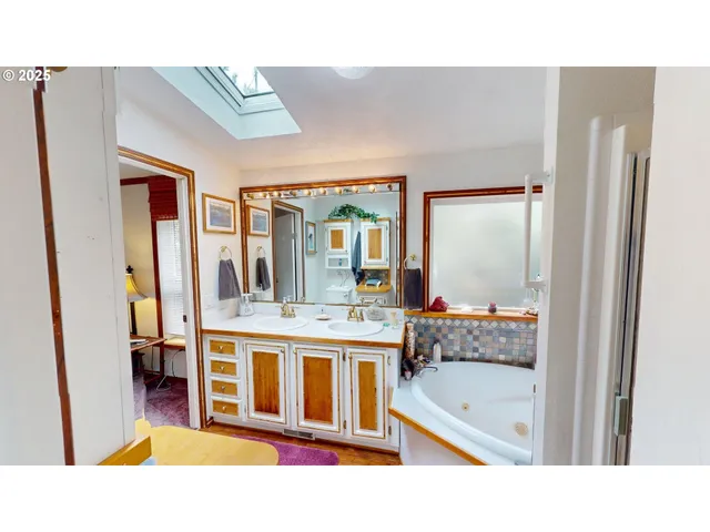 a bathroom with a tub sink and mirror
