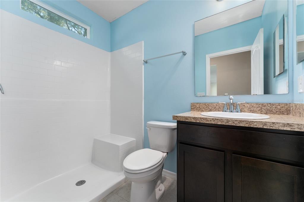 4331 Wayne Road Fruitland Park, FL 34731 - Photo 22 of 46 a bathroom with a granite countertop sink toilet and shower