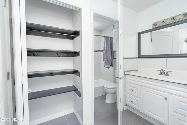 a bathroom with a toilet sink and a mirror