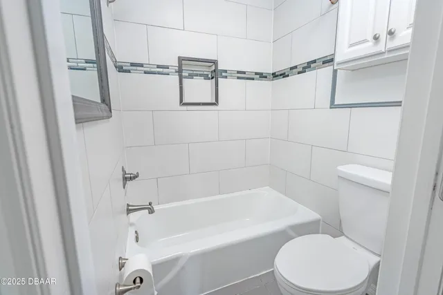 a bathroom with a toilet and shower