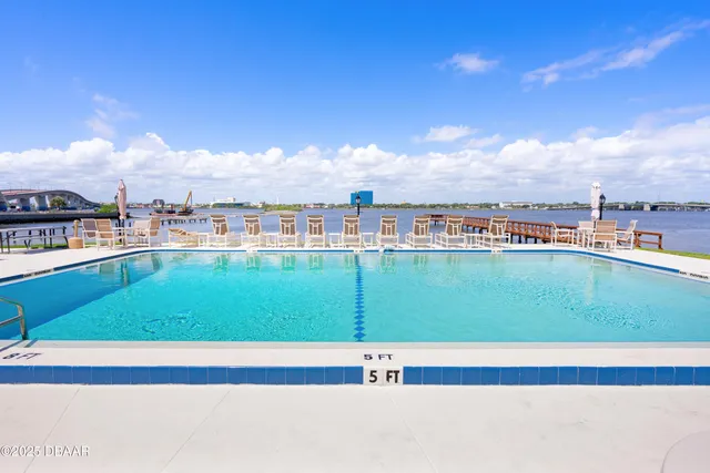 a view of a patio with table and chairs and potted plants