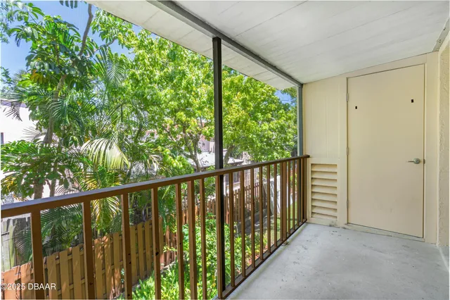 a view of a balcony with wooden floor