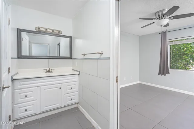 a bathroom with a sink a light fixture and a mirror
