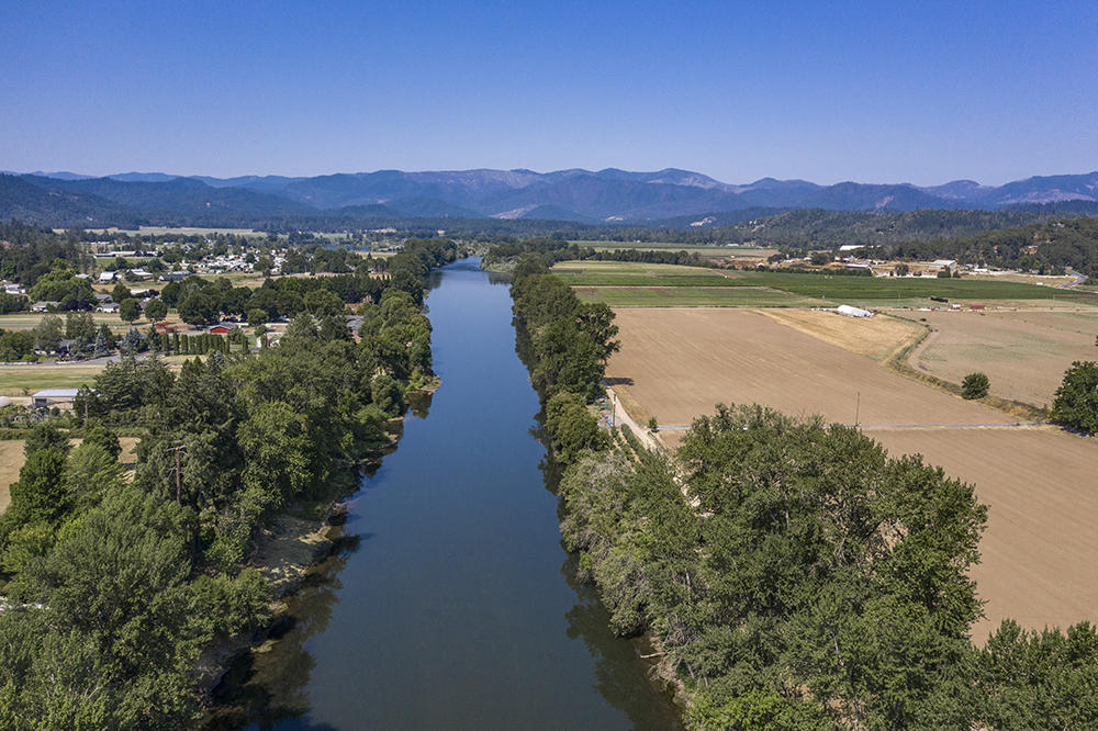 4028 Leonard Road Grants Pass, OR 97527 - Photo 4 of 26 a view of a lake with a mountain