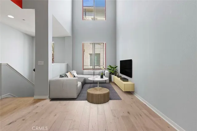 a living room with furniture wooden floor and a flat screen tv