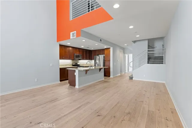 a kitchen with stainless steel appliances granite countertop a sink and a stove top oven