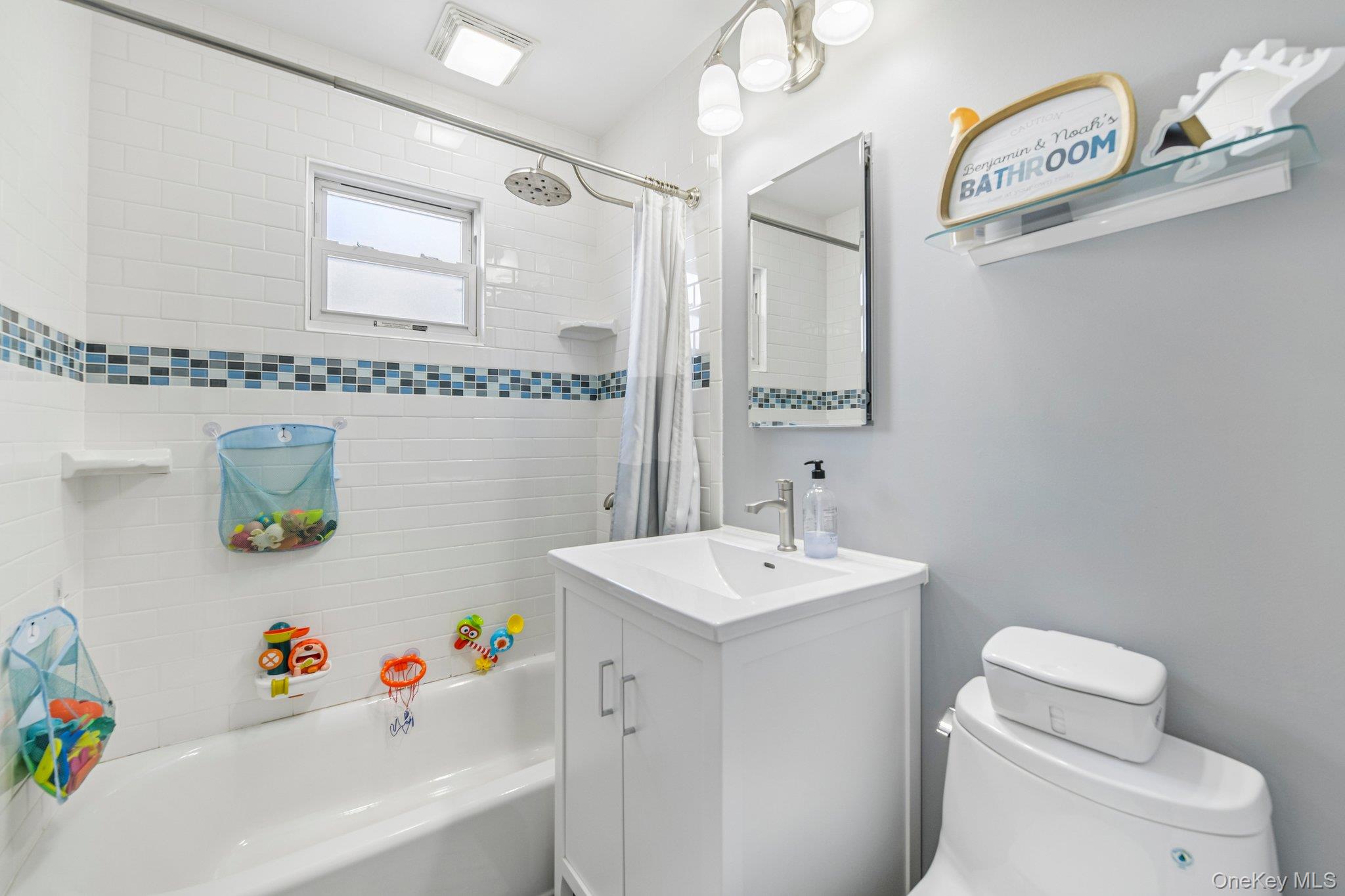 2821 Colonial Avenue Merrick, NY 11566 - Photo 13 of 29 a bathroom with a sink mirror vanity and toilet