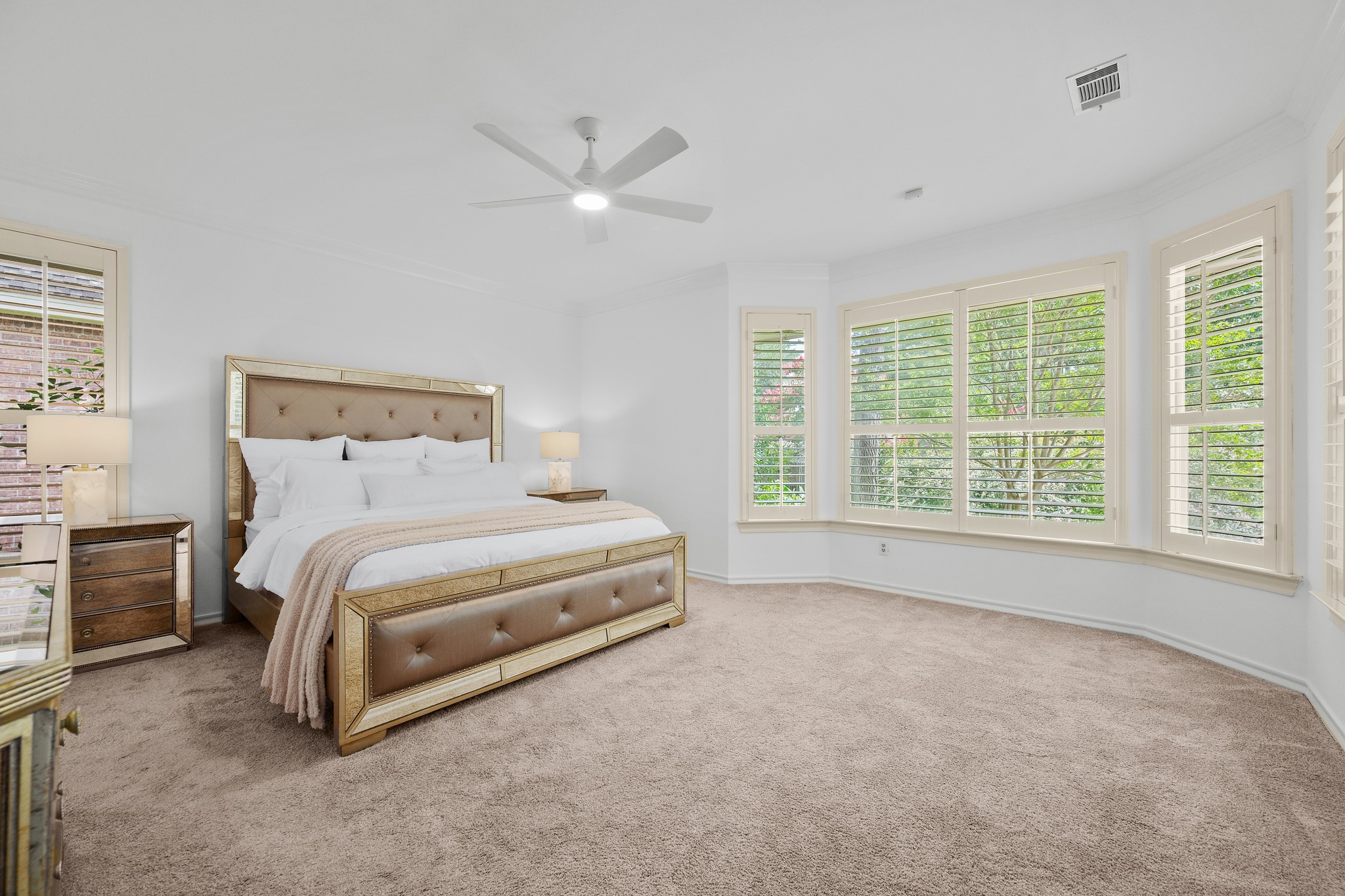 30115 Sawgrass Trail Georgetown, TX 78628 - Photo 11 of 37 A well-lit primary bedroom features ample floor space and large windows with privacy shutters.