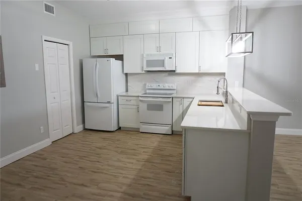 a kitchen with cabinets and stainless steel appliances
