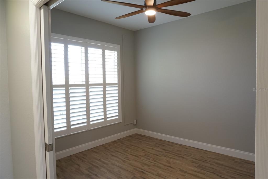 2000 Bal Harbor Boulevard, Unit 1012 Punta Gorda, FL 33950 - Photo 29 of 61 an empty room with wooden floor fan and windows