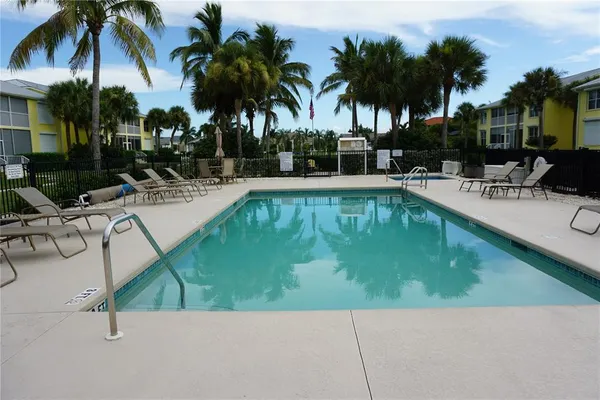 a view of swimming pool with outdoor seating and a patio