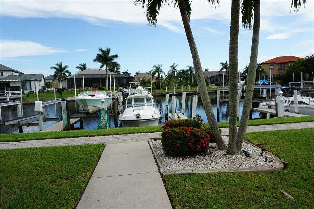 2000 Bal Harbor Boulevard, Unit 1012 Punta Gorda, FL 33950 - Photo 43 of 61 a view of a lake with couches and wooden fence
