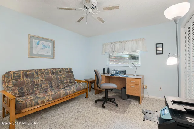 a bathroom with a granite countertop sink a toilet and a shower