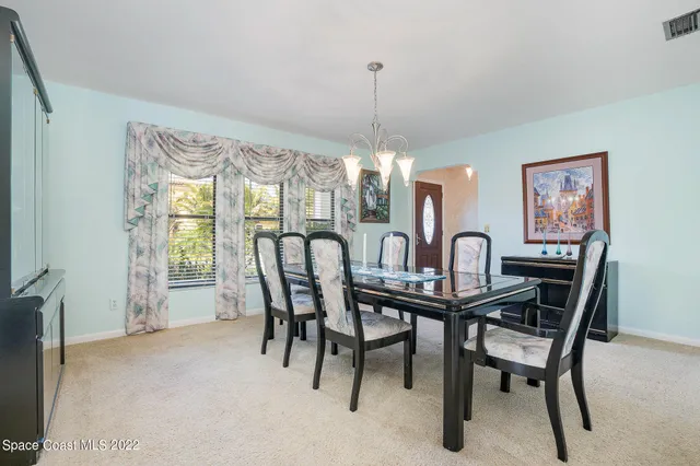 a view of a dining room with furniture window and outside view