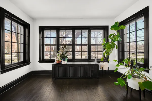 a living room filled with furniture and a large window