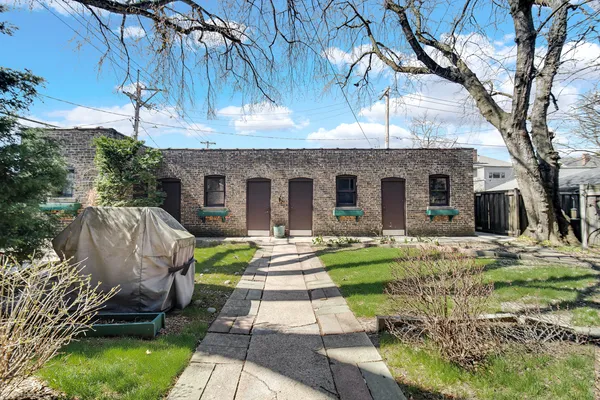 a front view of a house with a yard table and chairs