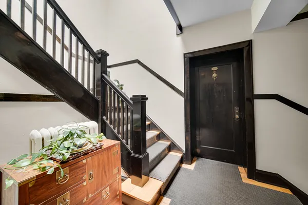 a view of entryway and hall with wooden floor