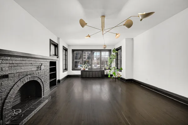 a view of livingroom with furniture fireplace and window