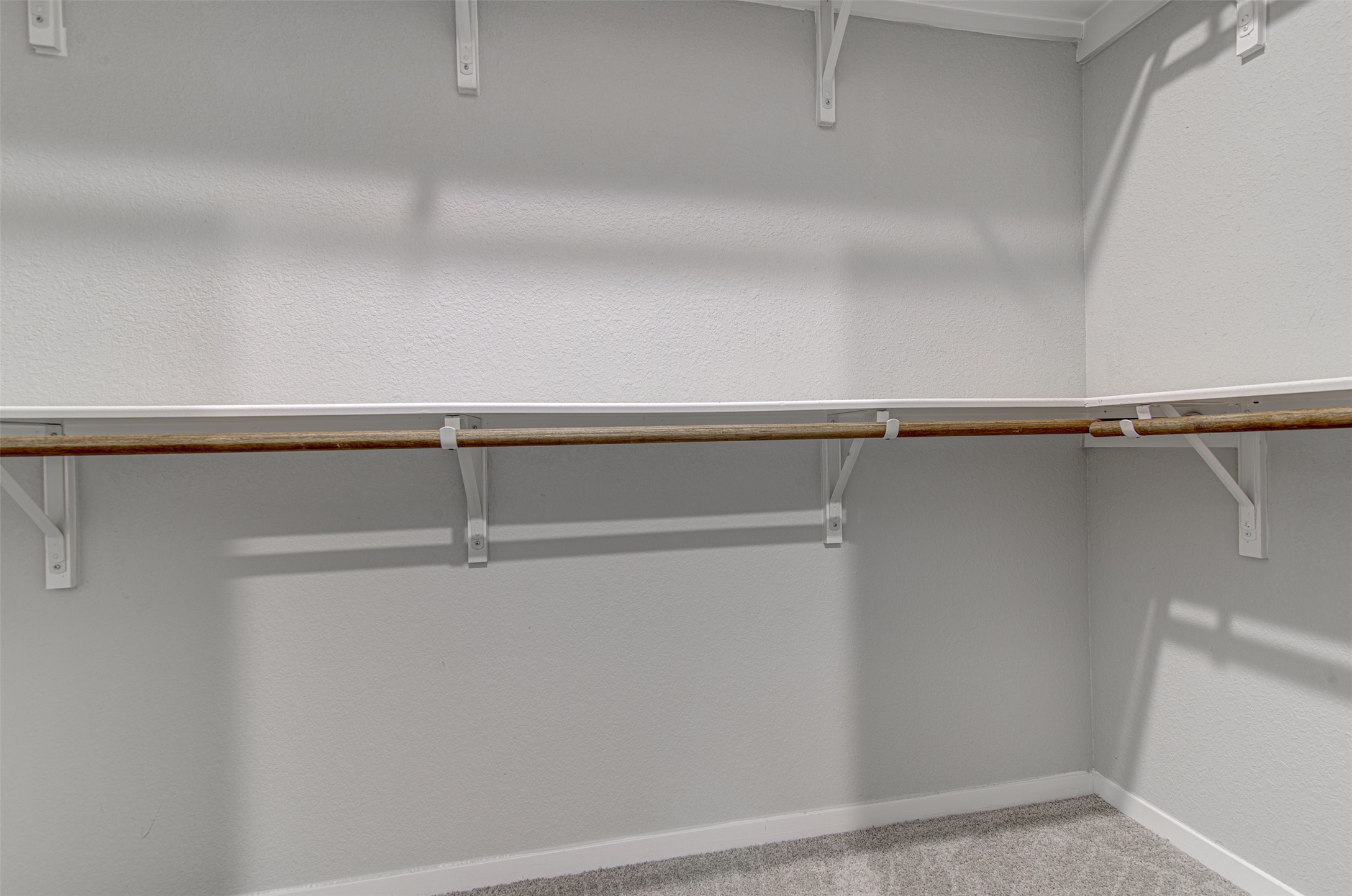 156 Tillage Road Elgin, TX 78621 - Photo 20 of 25 Ample shelving and hanging space characterize this well-appointed walk-in closet.