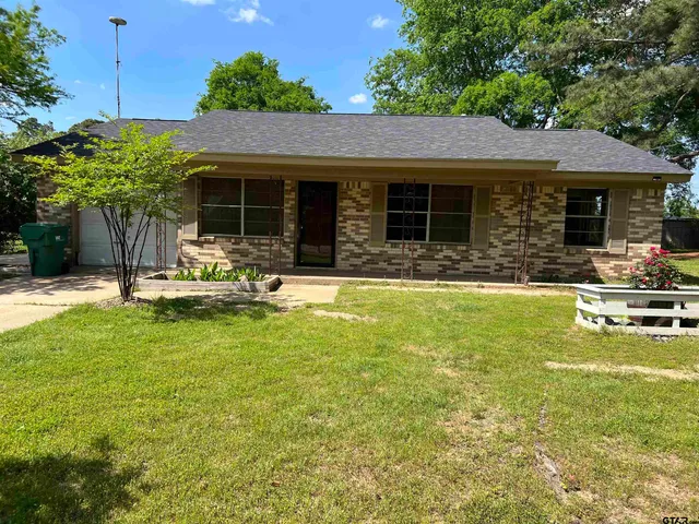 a view of a house with pool and chairs
