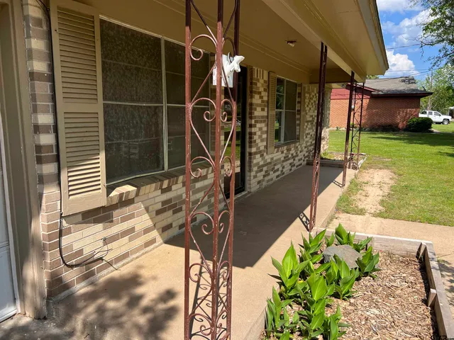 a view of a porch with potted plants