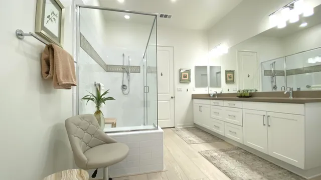 a spacious bathroom with a granite countertop sink a mirror a bathtub and shower