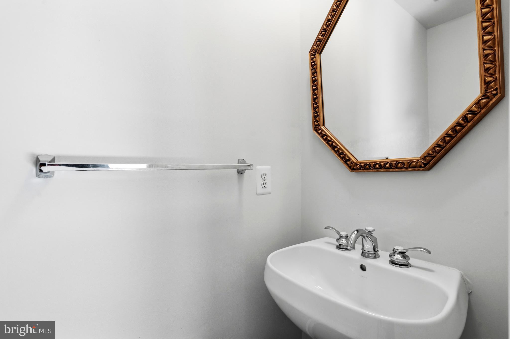 9227 Ribbon Falls Loop Bristow, VA 20136 - Photo 5 of 53 a bathroom with a sink and a mirror