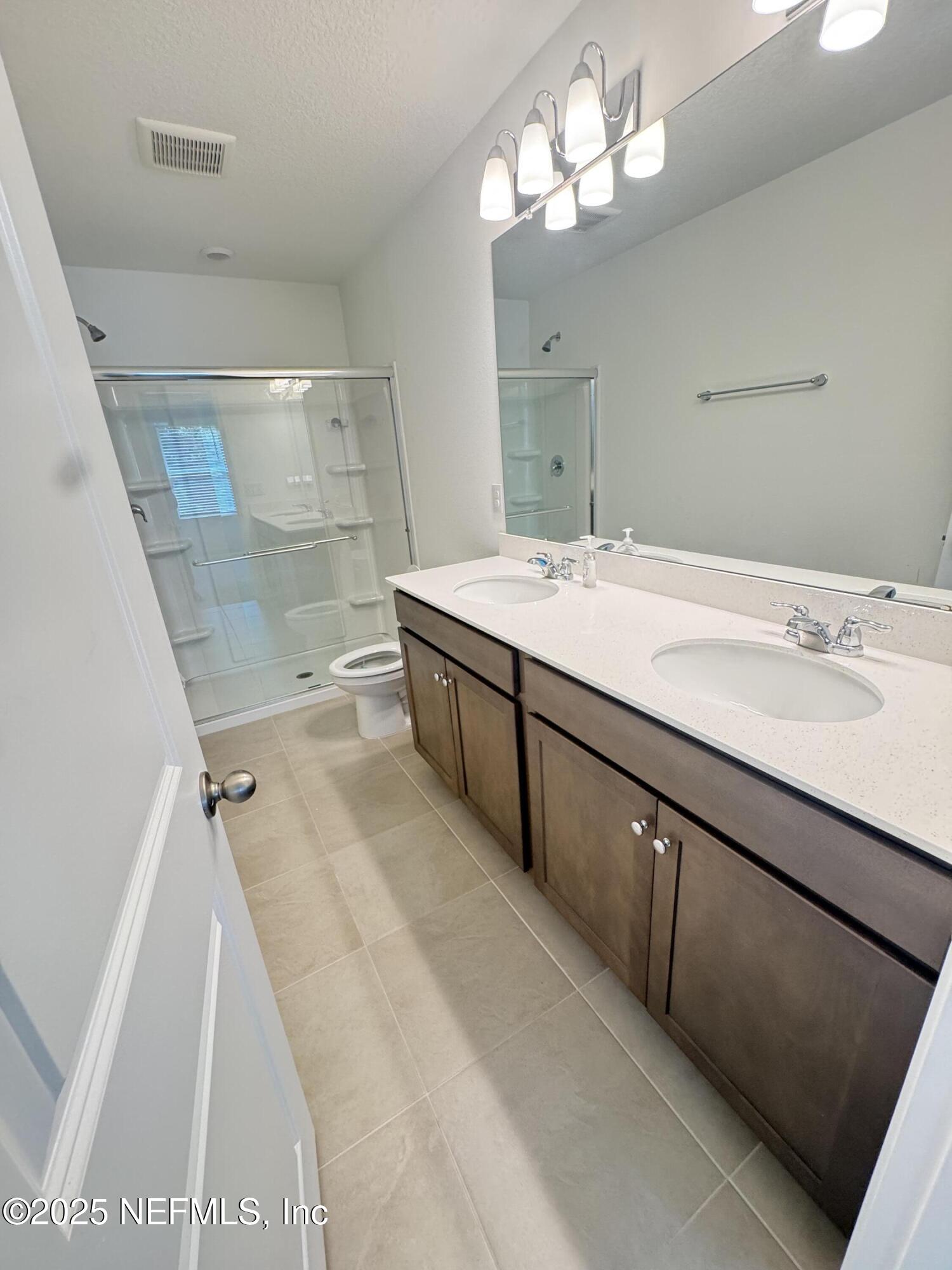 13505 Ute Jacksonville, FL 32218 - Photo 24 of 34 a bathroom with a double vanity sink and a mirror