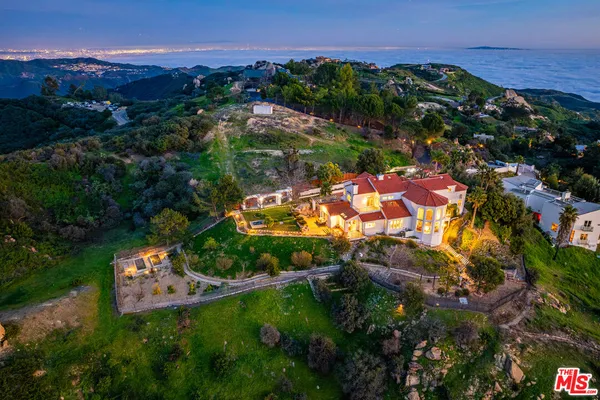 an aerial view of a house with a garden