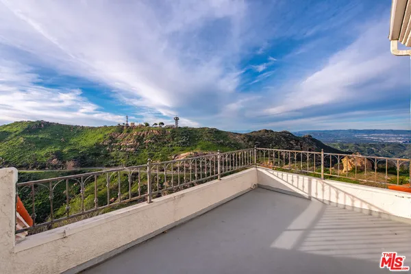 a view of a balcony with city view