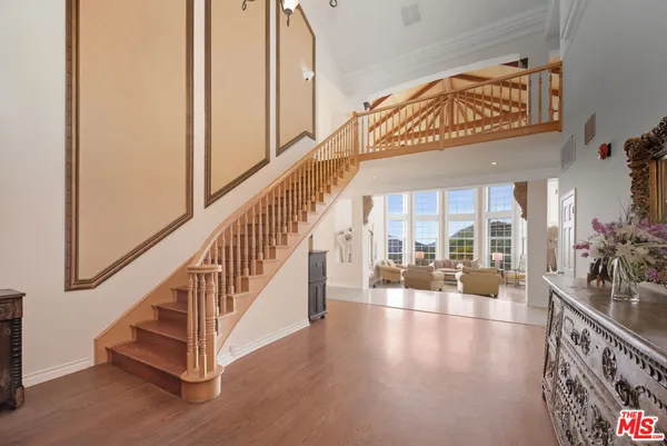 a view of an entryway with wooden floor