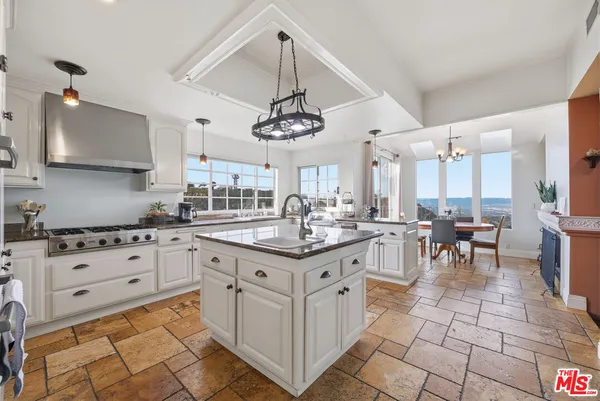 a kitchen with granite countertop cabinets a sink and a stove