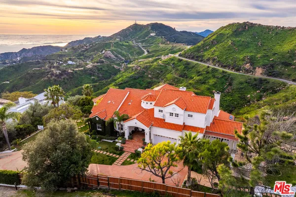 an aerial view of a house with a garden