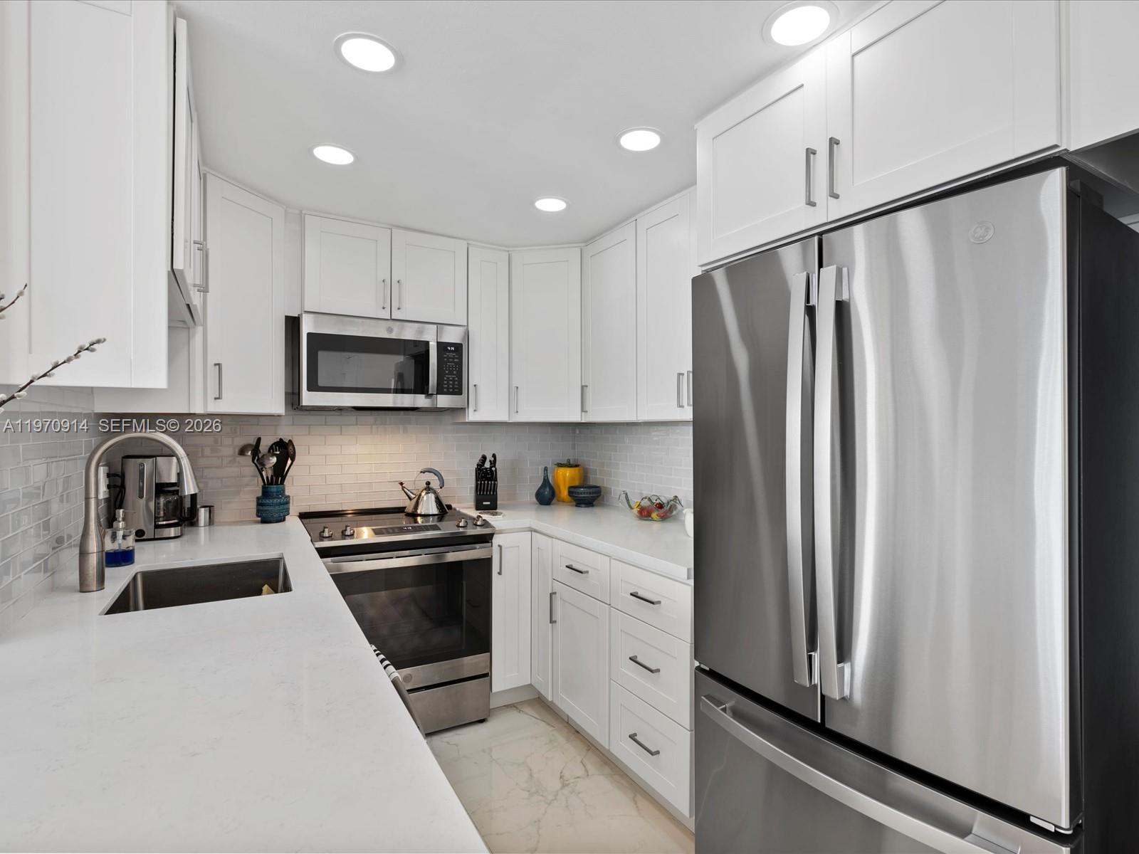 336 North Birch Road, Unit PH Fort Lauderdale, FL 33304 - Photo 8 of 68 a kitchen with stainless steel appliances granite countertop a refrigerator sink and stove