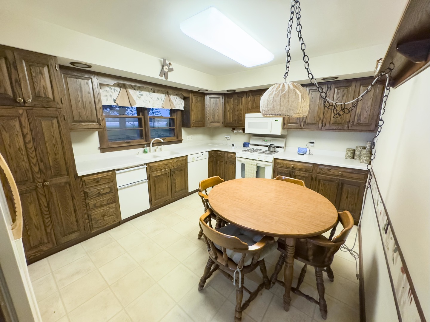 19256 1330 E Road Pontiac, IL 61764 - Photo 16 of 36 a kitchen with stainless steel appliances granite countertop a sink a stove a refrigerator cabinets and chairs